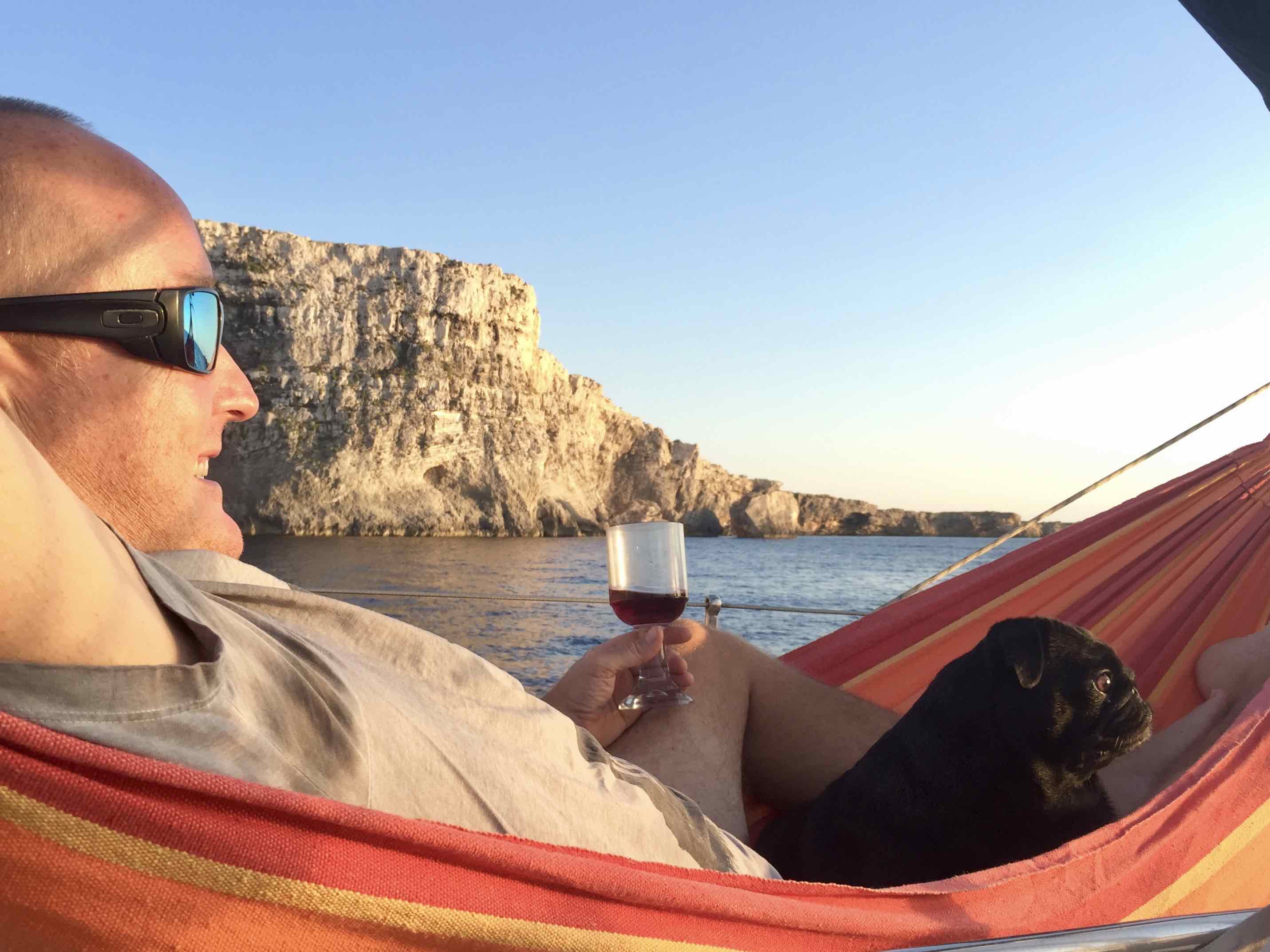 Relaxing in the hammock with a glass of wine and the dog